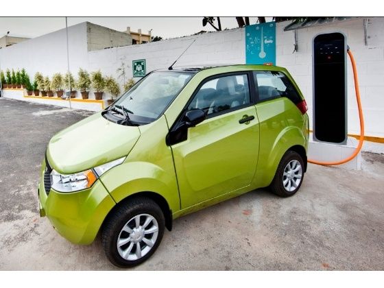 Mahindra Reva e2o electric car hooked to a charging station Mahindra Reva e2o electric car hooked to a charging station